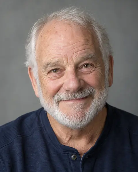 Hazel's dad, with white hair and a short beard